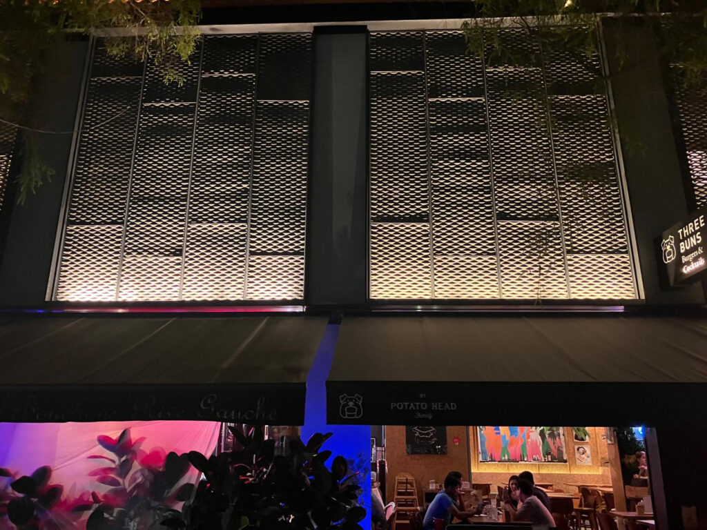 a restaurant with a metal mesh facade